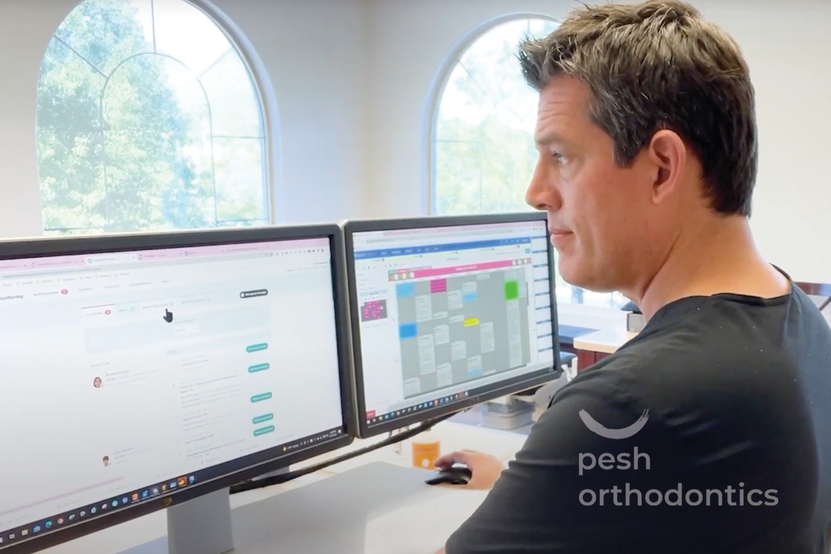 Dr. Pesh reviewing orthodontic treatment materials on a digital screen inside his Murrieta orthodontic office.