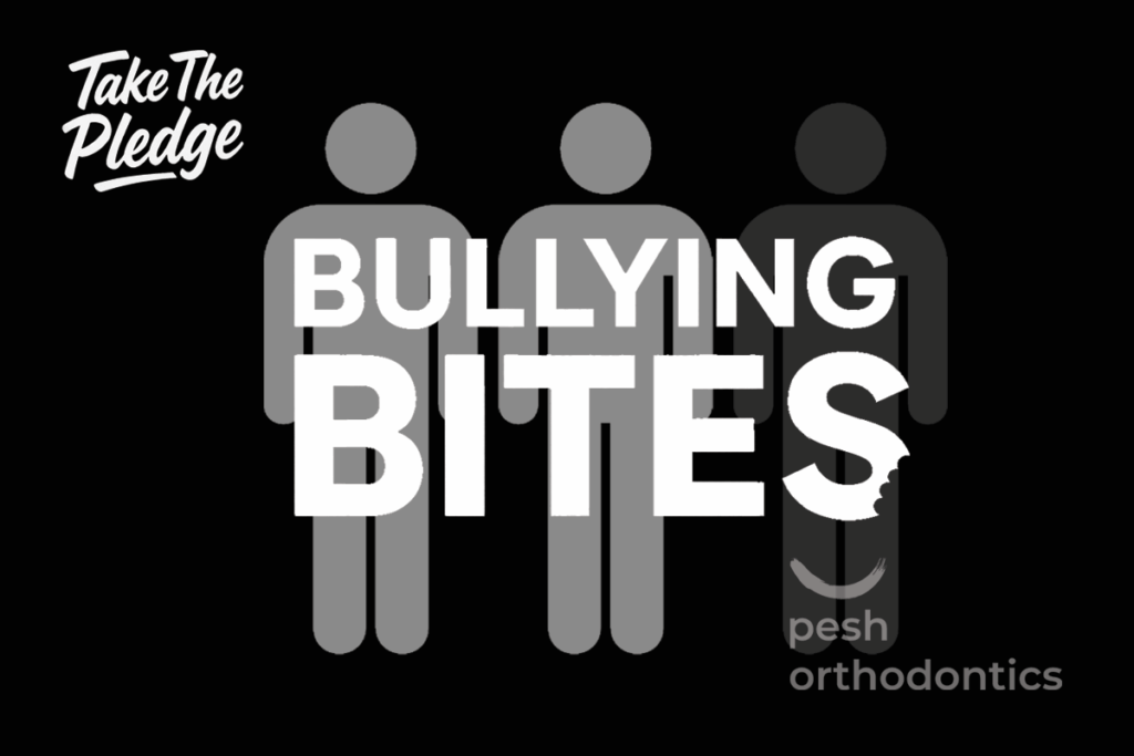 Dr. Shawn Pesh and the Pesh Orthodontics team holding Bullying Prevention pledge signs during the Bullying Bites campaign.