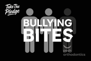 Dr. Shawn Pesh and the Pesh Orthodontics team holding Bullying Prevention pledge signs during the Bullying Bites campaign.