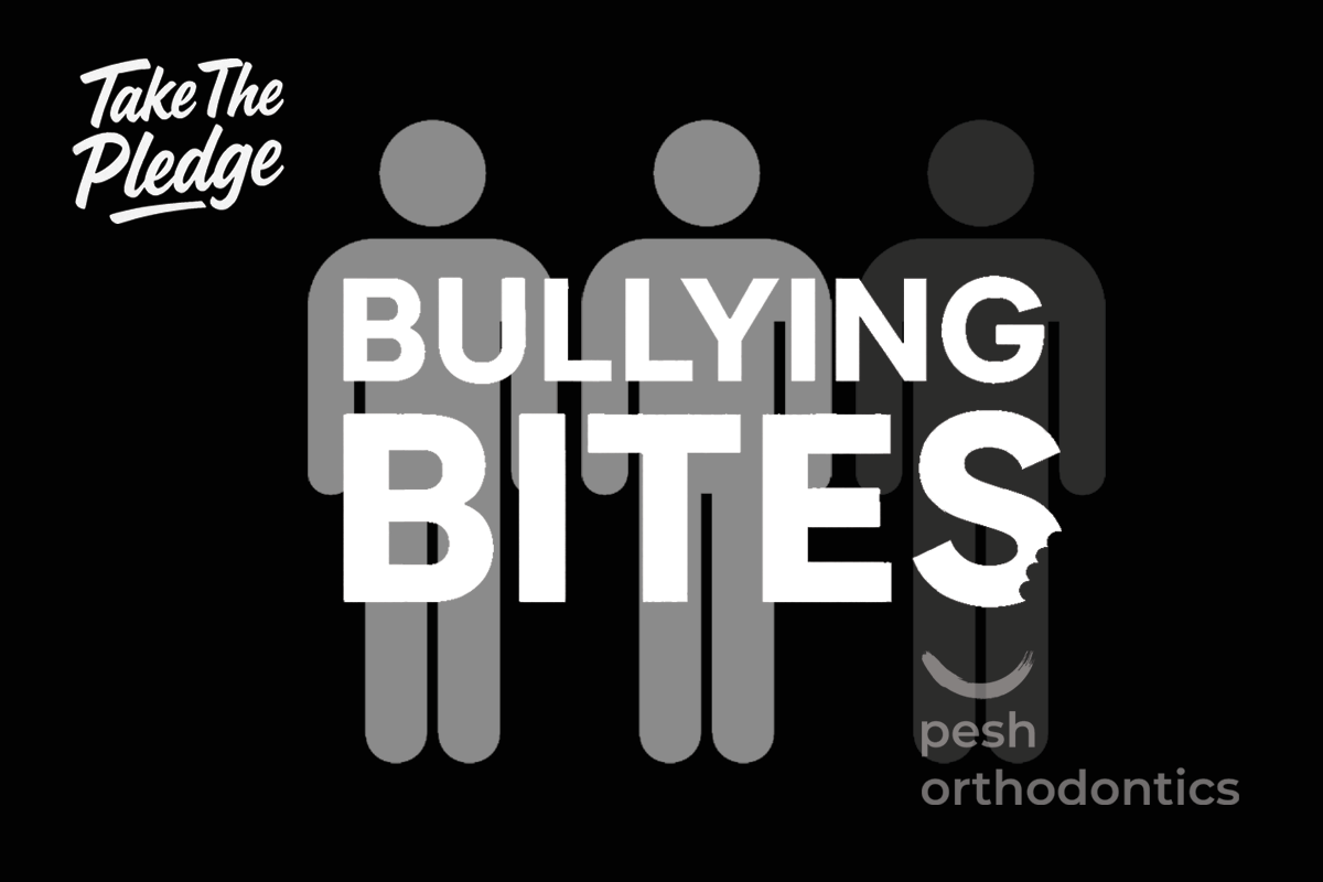 Dr. Shawn Pesh and the Pesh Orthodontics team holding Bullying Prevention pledge signs during the Bullying Bites campaign.